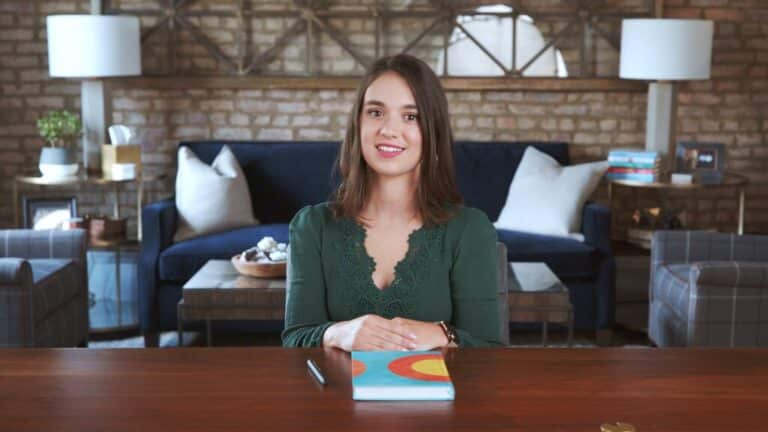 young woman sitting at a desk for an interview