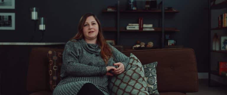 woman being interviewed sitting on a couch
