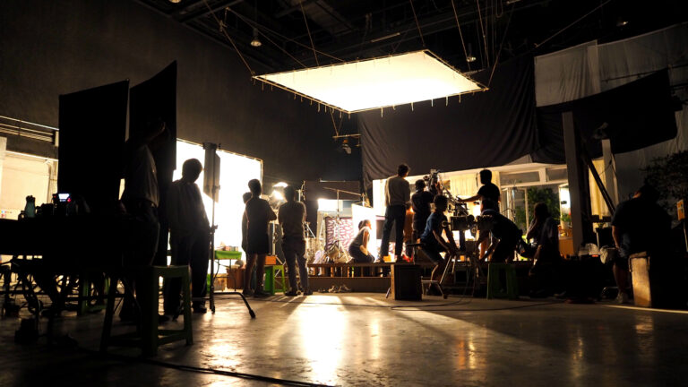video production crew working on a movie set indoors
